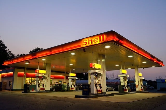 gas station lit up at dusk 