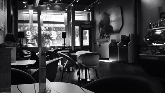 black and white photo of an empty coffee shop on the how to demonstrate popularity and authority on google page