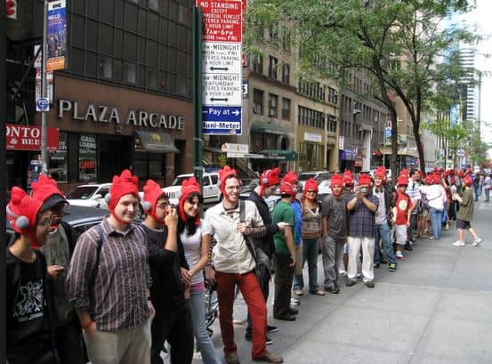 snapshot of Customers wearing rooster hats while waiting in line for the start of Scribblenauts launch event